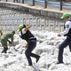 Security forces and soldiers try to clear away ice after a heavy storm of rain and hail in Guadalajara